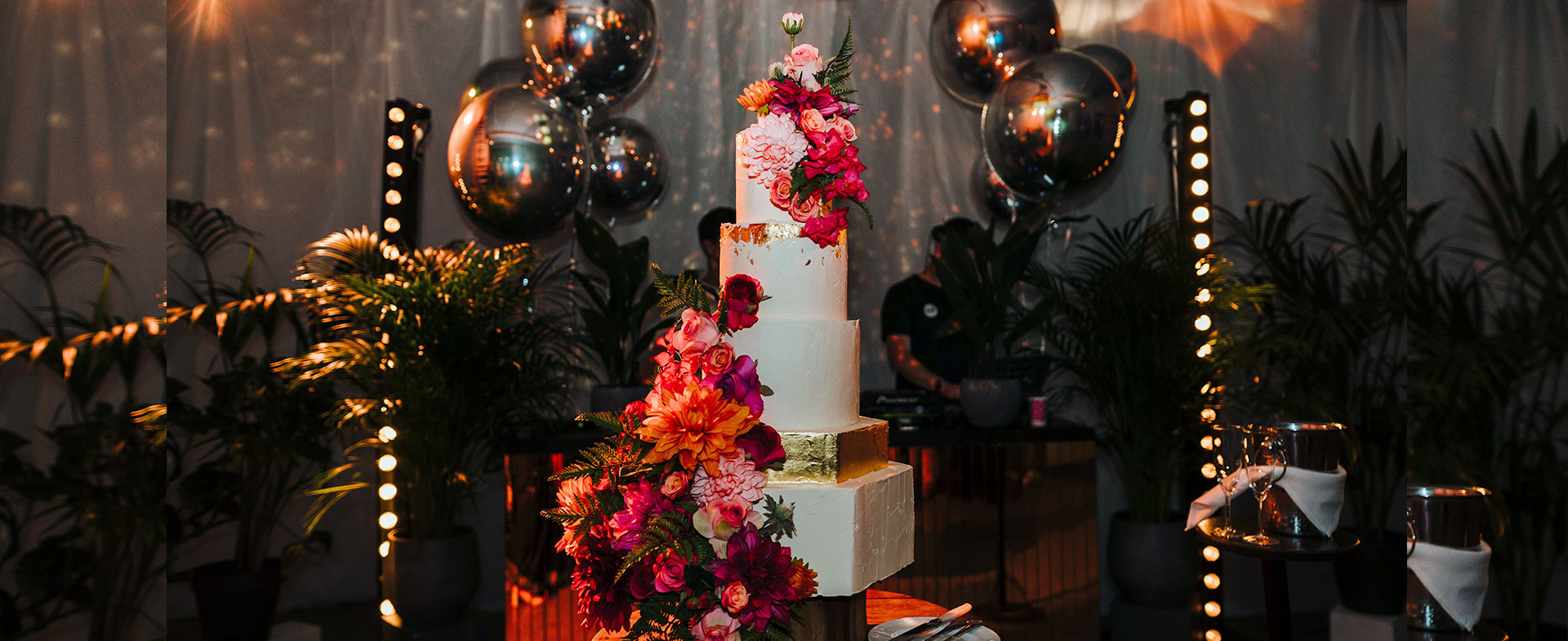 Hexagon Wedding Cake with a Gold Tier & Bright Flowers Full